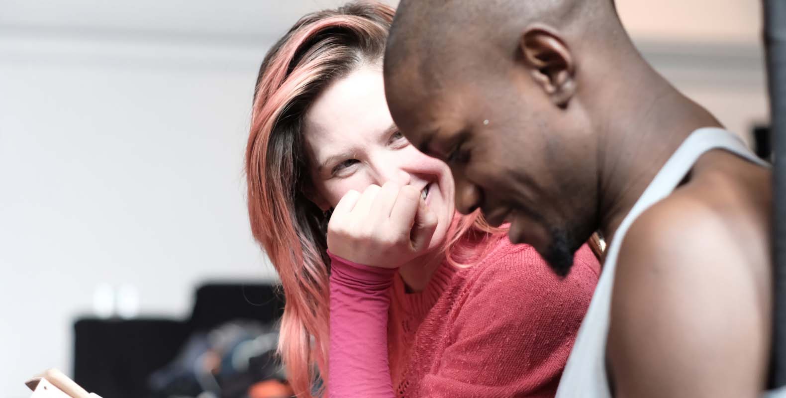Woman laughing with smiling man.